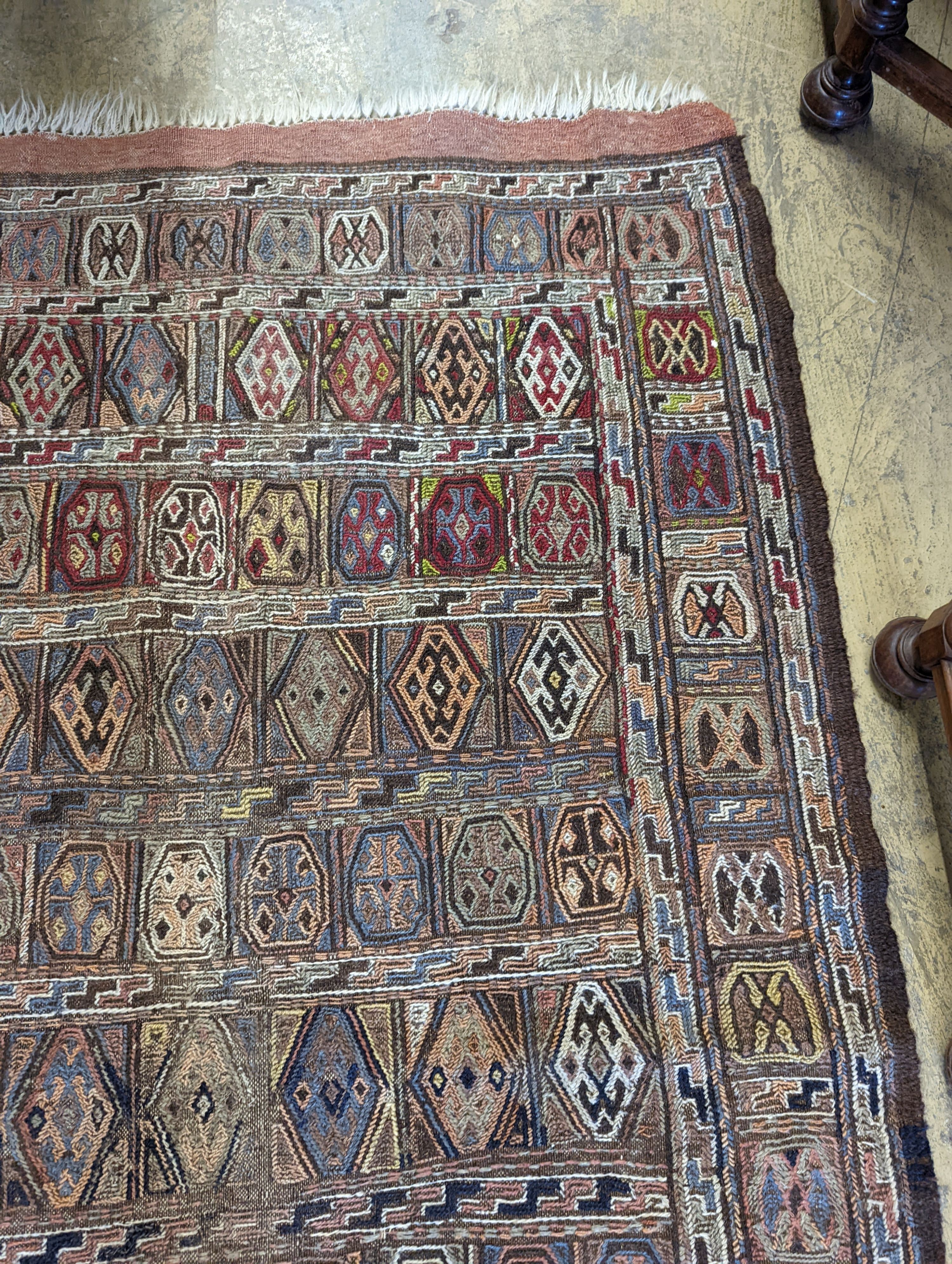 A Sumac flat weave polychrome rug, 180 x 108cm